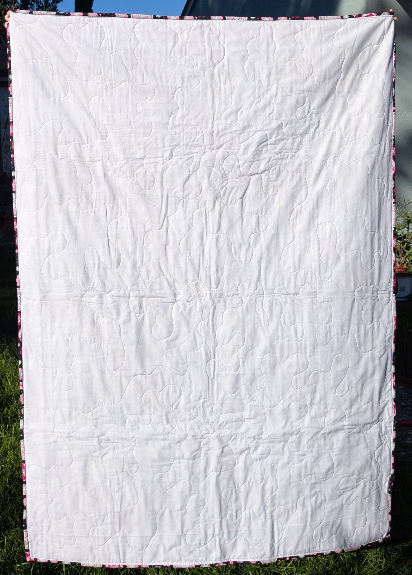 Pink and black throw quilt