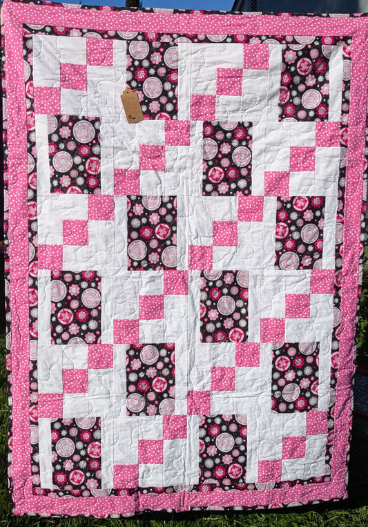 Pink and black throw quilt